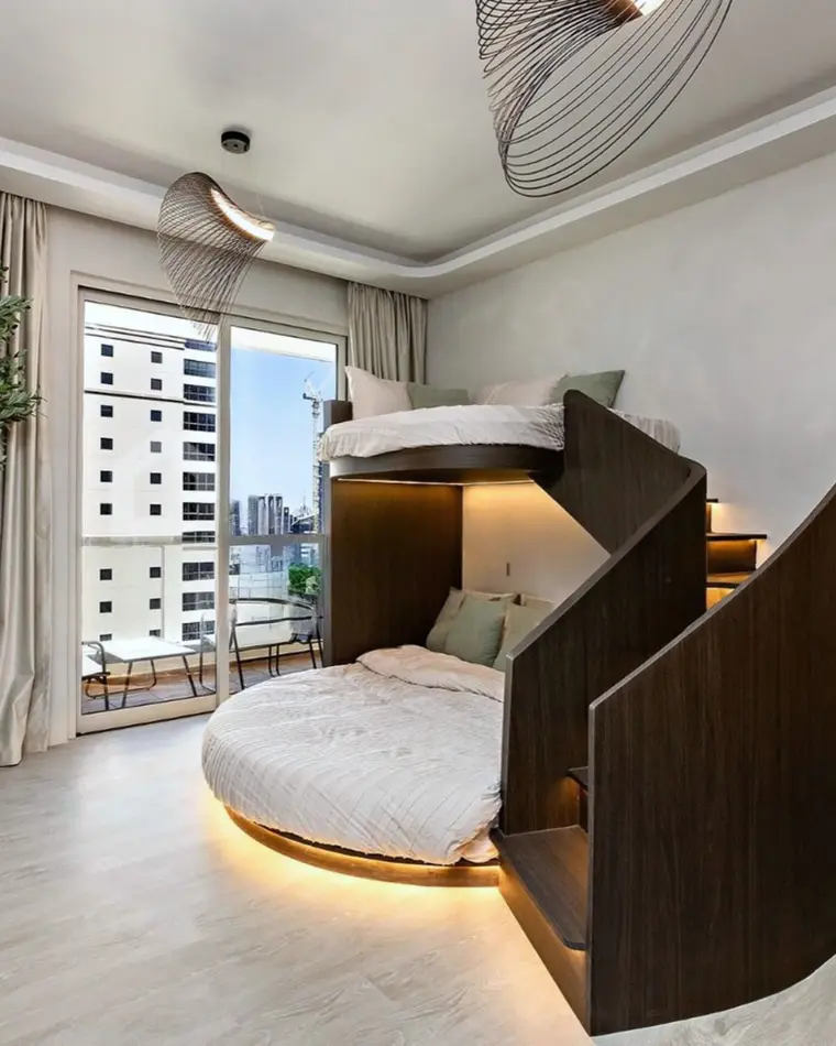 Kids room in JBR: a walnut mezzanine bed with a staircase and a lit base.