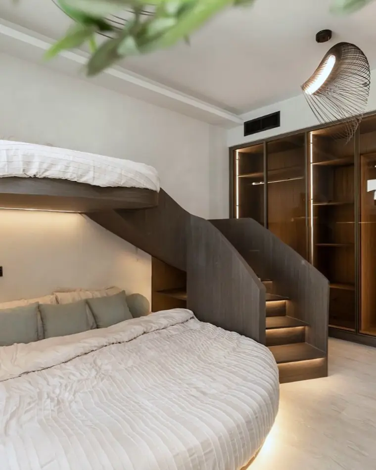 Kids room in JBR: a walnut bunk bed with a staircase and joinery beneath.